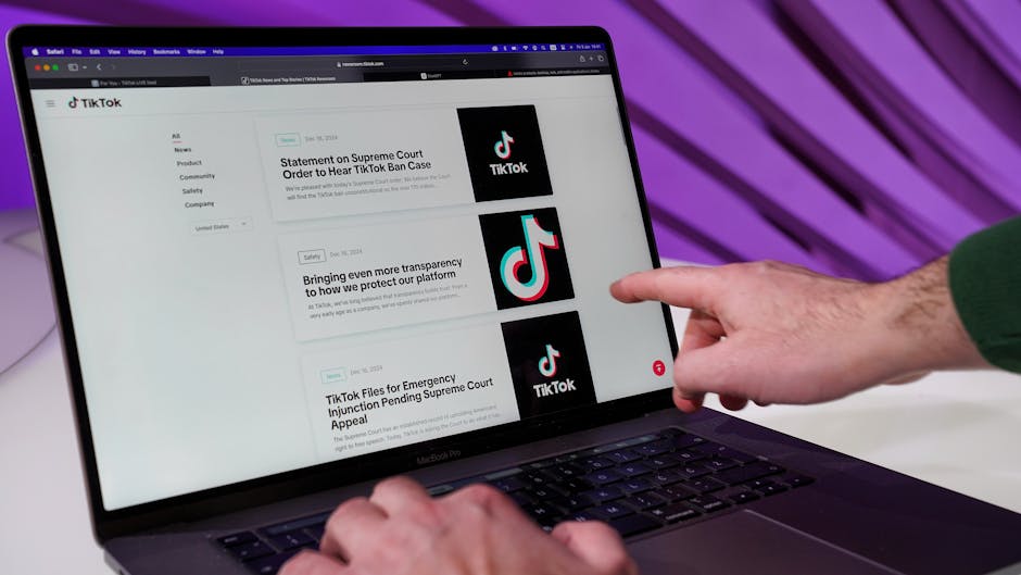 Close-up of a person interacting with TikTok content on a laptop indoors.
