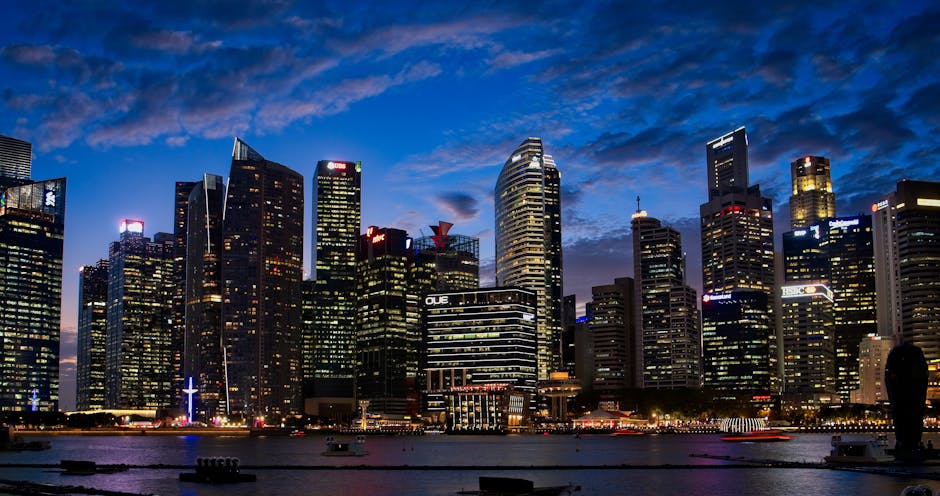 Spectacular view of Singapore's skyline with illuminated skyscrapers against a twilight sky.