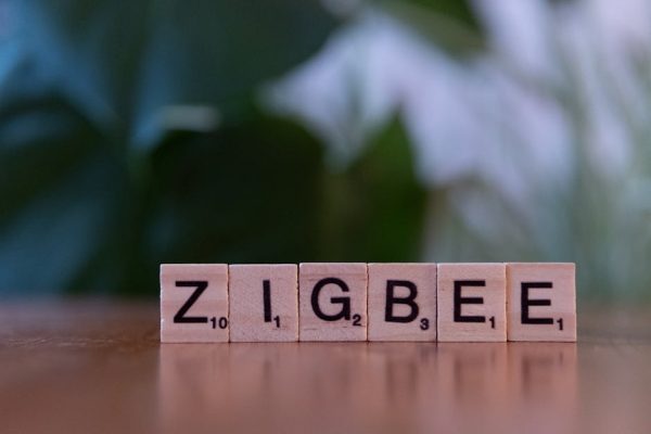Wooden letter tiles spelling 'ZIGBEE' representing Zigbee wireless technology.