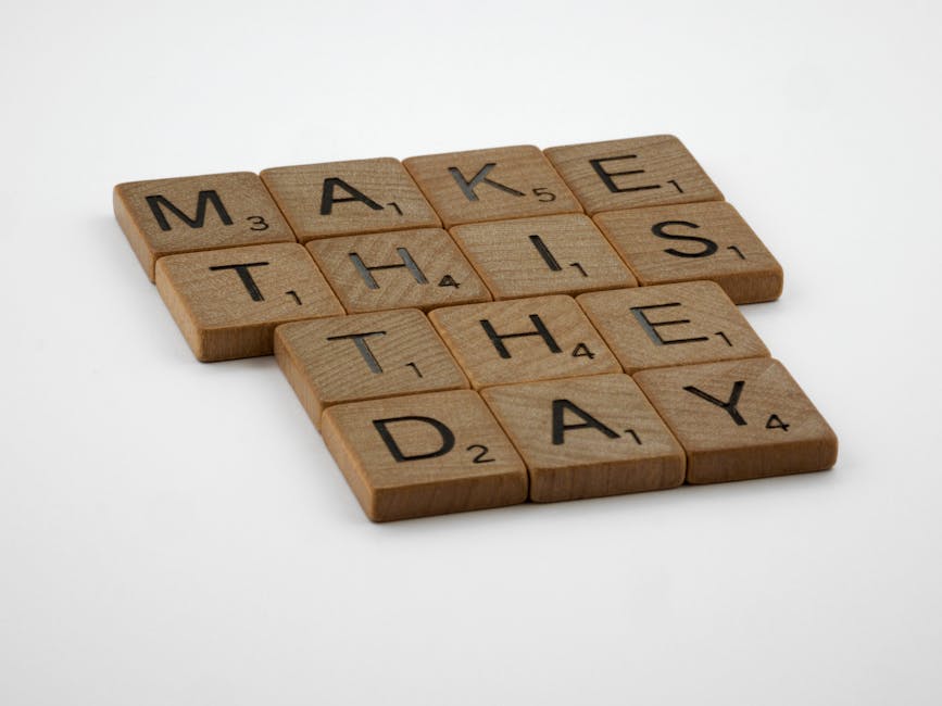 Wooden Scrabble tile pieces arranged to spell 'Make this the day'.
